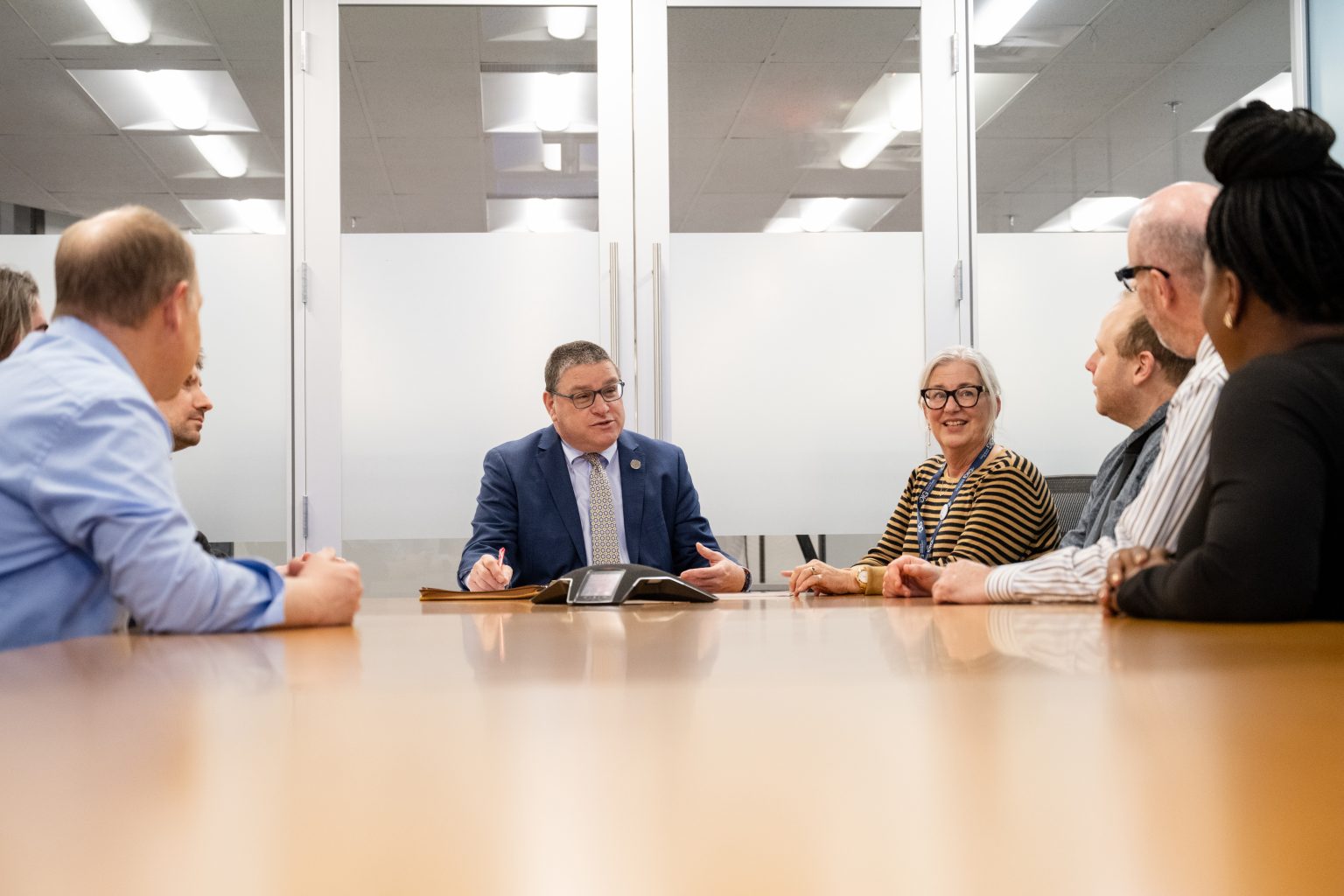 IG Shapiro meets with staff members at a conference table.